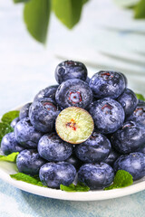 Fresh Yunnan Mountain Blueberries with Water Droplets on White Plate - High Quality Berry Fruit Duo © NguyenVan