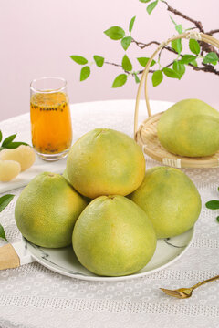 Fresh Green Pomelos on Plate with Juice and Natural Styling