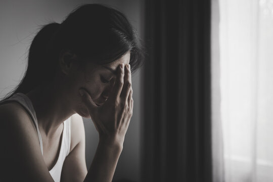 A depressed woman crying in fear, symbolizing abuse, family problems, exploitation, and the fight for women's safety, dignity, freedom, and peace.