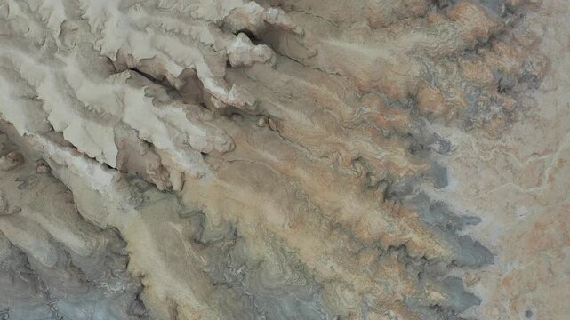 Aerial view of the eroded rock formations and arid landscape of Mount Zin in the Negev desert, Yeruham, South District, Israel.