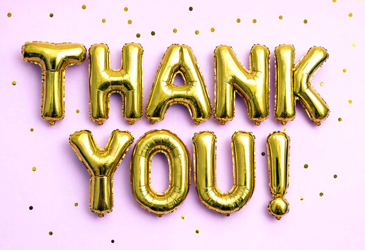 Golden thank you foil balloons with shiny surface and confetti background perfect for celebrations and appreciation events