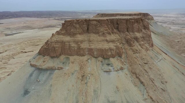 Aerial view of Mount Zin in the Negev desert with rugged cliffs and arid landscape in Yeruham, South District, Israel.
