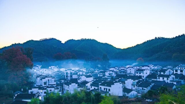 Sunrise, autumn colors, and beautiful rural scenery at Shicheng Red Maple Scenic Area in Wuyuan City, Shangrao County, Jiangxi Province, China.