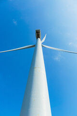 Naklejka premium Low Angle Wind Turbine Against Clear Blue Sky