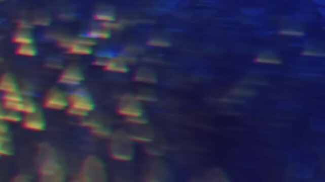 Sparkling glare art. Blurred gleam. Duplicated lens flare prism stroboscopic colorful rotation. Shiny light leak blue yellow abstract bokeh background.
