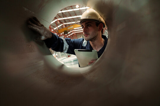 Engineers and staff are inspecting the assembly line system in a metal sheet and metal roofing manufacturing plant.