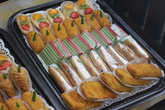 Assorted Bite Size Pastries and Assorted Rods on Tray in Display