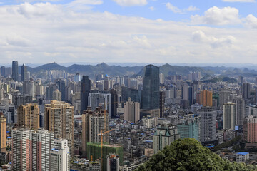 Fototapeta premium Asian City Skyline with Mountains - Urban Landscape Panorama