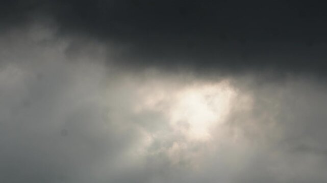 Dark storm clouds breaking with dramatic sunlight