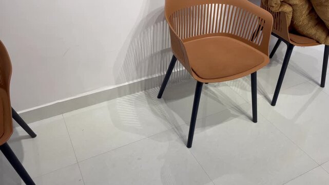 Modern Brown Plastic Chairs with Black Legs in Clean Indoor Room