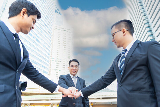 Business executives shaking hands at an industrial energy site, symbolizing partnership, investment, and corporate success