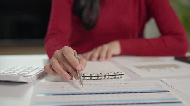 Financial analyst examining business report document