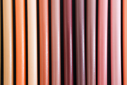 close-up of ochre brown and skin tones pencils neatly lined up in pencil case, concept of creativity, drawing, education and art supplies
