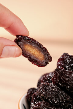 Dried Purple Jujube Fruit from Xinjiang - Hand Holding Sweet Date with Golden Interior