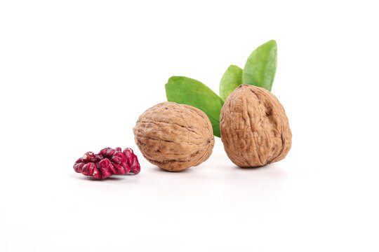 Xinjiang Walnuts with Red Kernel and Green Leaves on White Background
