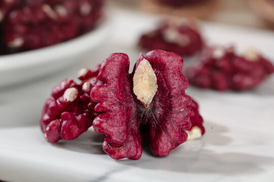 Red Walnut Kernels from Xinjiang China Closeup Display on White Paper