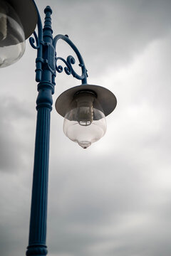 Elegant blue street lamp against a moody sky