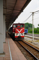 Red diesel locomotive at the train station, ready for departure. © Vuang