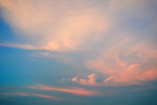 Soft pastel clouds in a serene evening sky.
