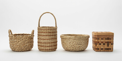 Obraz premium Four handwoven wicker and rattan baskets in different shapes and natural textures