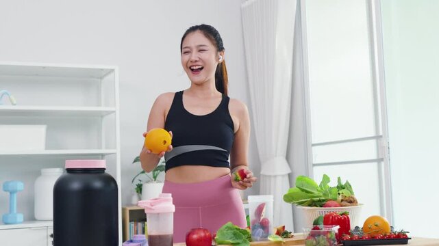 Fit Asian woman presenting organic food recipes for fitness goals on vlog channel. Sporty female content creator recording health and wellness tips with mobile phone camera.