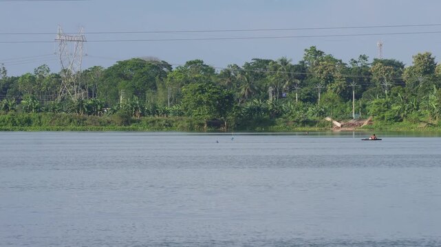 River landscape with green trees and blue sky
