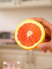 Fresh Blood Orange Half Held in Hand - Citrus Fruit Cross Section with Vibrant Red Flesh © Nguyen