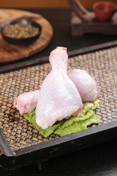 Fresh Raw Chicken Thighs and Legs on Bamboo Mat Ready for Grilling