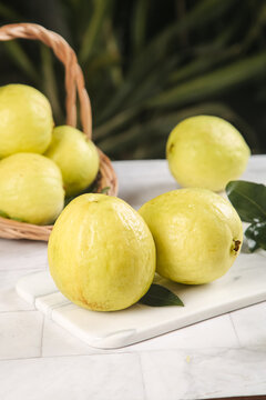 Fresh Yellow Guava Fruits on White Cutting Board - Tropical Fruit Showcase
