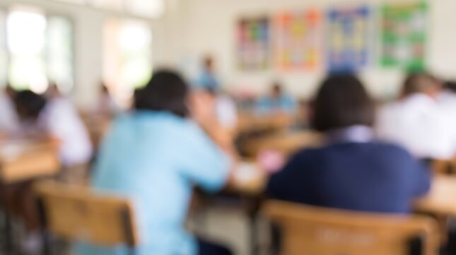 Blurred view of students in classroom setting during lesson with focus on learning environment and educational atmosphere in school building for academic development and student growth