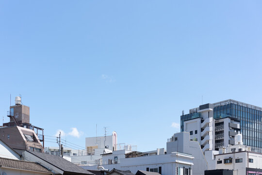 Cityscape of Fukuoka, Japan with mixed buildings and expansive blue sky copy space