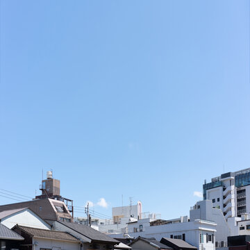 Cityscape of Fukuoka, Japan with mixed buildings and expansive blue sky copy space