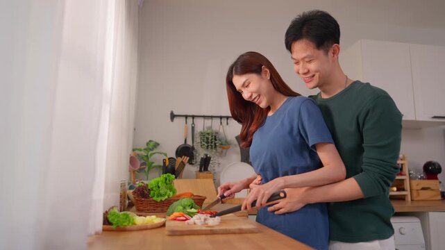 Asian young new marriage couple spend time together in kitchen at home. 