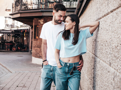 Smiling beautiful woman and her handsome boyfriend. Woman in casual summer jeans clothes. Happy cheerful family. Female having fun. Sexy couple posing in the street at sunny day