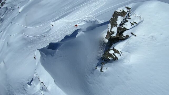 Timelapse showing freeriders carving fresh lines across deep powder in the Tortin sector of Verbier, the iconic freeride face gradually filling with tracks as skiers descend.
