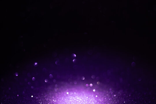 Dark purple glitter background with glowing bokeh for Halloween, Mardi Gras, birthday party banner or festive backdrop