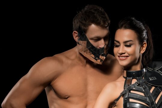 Elegant couple poses in front of a black background