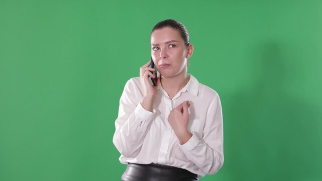 Young woman office employee standing with mobile phone, answering call on chroma key background . High quality 4k footage