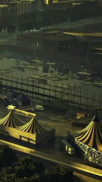 Colorful tents illuminate the waterfront during twilight. Boats rest peacefully in the harbor, creating a serene atmosphere for evening festivities.
