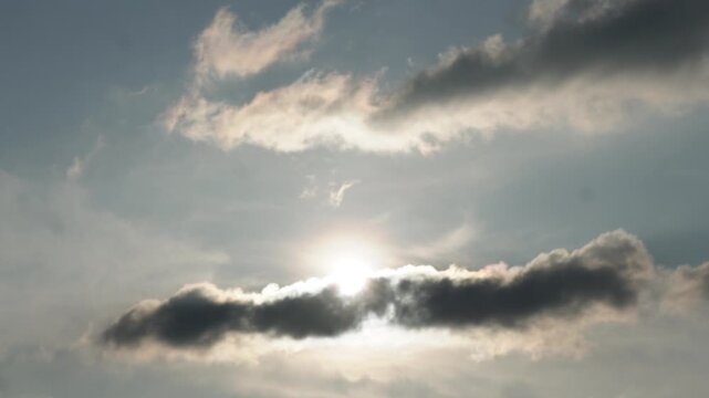 Bright sunlight breaking through dark dramatic clouds