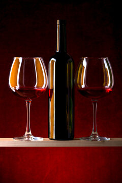 Still life with glasses of wine and a glass bottle