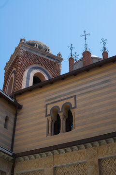 Decorative striped facade and architectural details of Rocchetta Mattei Castle in Grizzana Morandi, Emilia-Romagna, Italy.