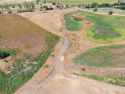 A striking drone photo series capturing the stark reality of climate change on the Great Hungarian Plain (Alf&ouml;ld), showcasing vast, cracked earth, sun-bleached yellow fields, and parched landscapes un