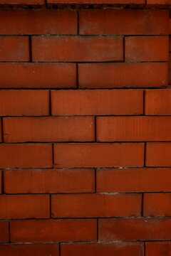 Red brickwork background with geometric ventilation slot design