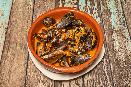 Steamed Mussels in Spicy Sauce Served in Traditional Clay Terracotta Bowl