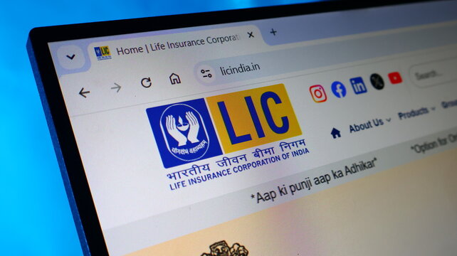 Lic india life insurance corporation website homepage displayed on monitor screen with blue background.