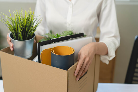 unemployed concept, employee clear her stuff at office to move out after get layoff from company in recession.