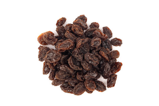Heap of dried dark raisins isolated on white background top view.