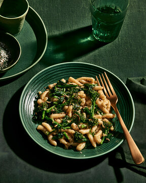 Cavatelli Pasta with Broccoli Rabe and Anchovy on a Textured Green Plate