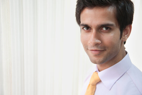 Portrait of good looking businessman smiling in office 